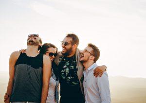 A group of friends laughing and hugging. 