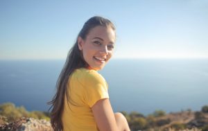 A woman looking over her shoulder and smiling. 