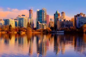 The view of Vancouver from a body of water during daylight. Moving to Vancouver means living in one of the world`s most beautiful cities.